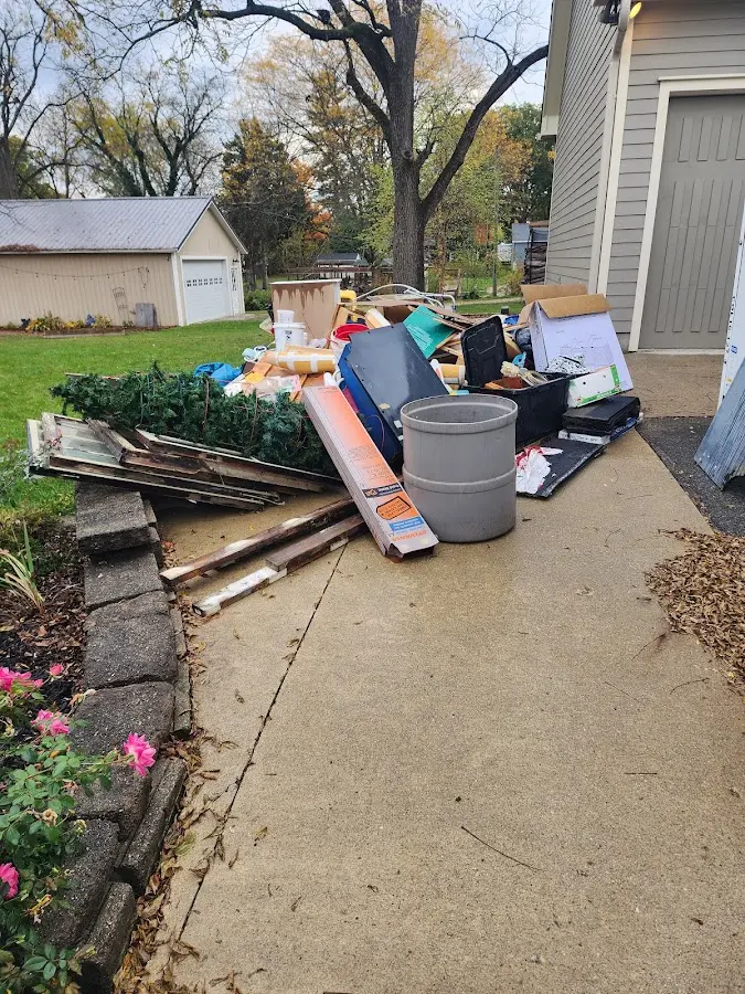 Dumpster being loaded with debris for Estate Cleanout Dumpster Rental in Pompano Beach
